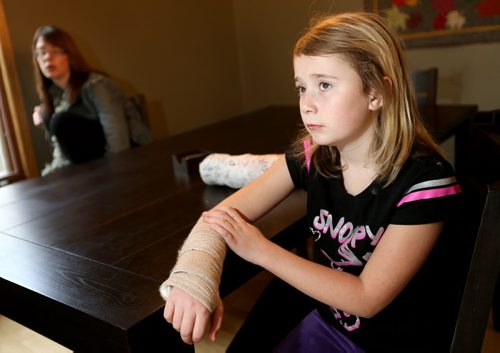 Leah Thorsteinson, 10, and her mother, Laurel Baron. Leah broke her arm at SkyZone, the indoor trampoline park that opened in August, Monday, October 21, 2013. (TREVOR HAGAN/WINNIPEG FREE PRESS)