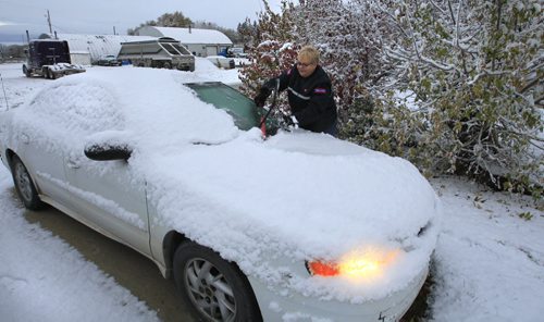 Warren, Manitoba  resident Joanne Baldwin clears the snow  from her car Tuesday morning after the overnight snow fall. She is heading to her job at the local post office.   weather story   Wayne Glowacki / Winnipeg Free Press Oct. 22 2013