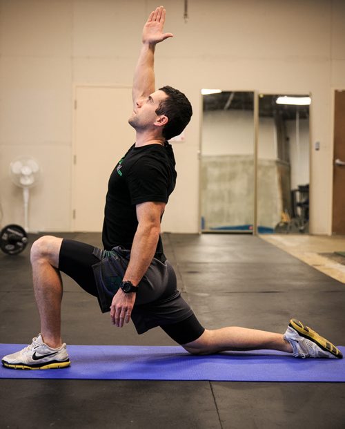 Athletic Therapist Tim Shantz demonstrates an extended hip flexor stretch. 131021 - Monday, October 21, 2013 - (Melissa Tait / Winnipeg Free Press)