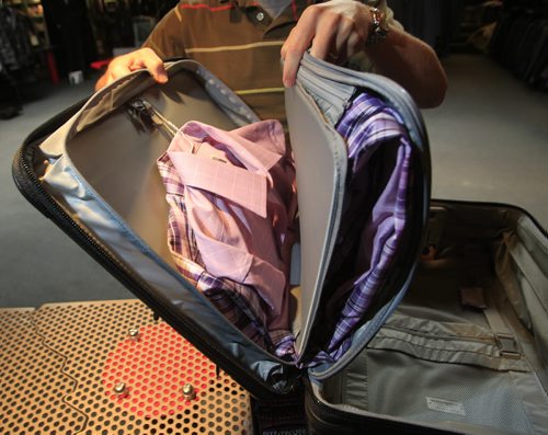 Fashion. Threads. At  Hanford Drewitt, Jon Thiessen of UN Luggage, demonstrates how to travel light. He is using the Briggs and Riley wide-body carry-on roll-aboard case.  Wayne Glowacki / Winnipeg Free Press Oct. 22 2013