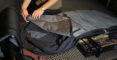 Fashion. Threads. At  Hanford Drewitt, Jon Thiessen of UN Luggage, demonstrates how to travel light. He is using the  Skyroll carry-on suit-carrying duffle bag to pack a Boss Travel suit that costs $1,450.00 .  Wayne Glowacki / Winnipeg Free Press Oct. 22 2013