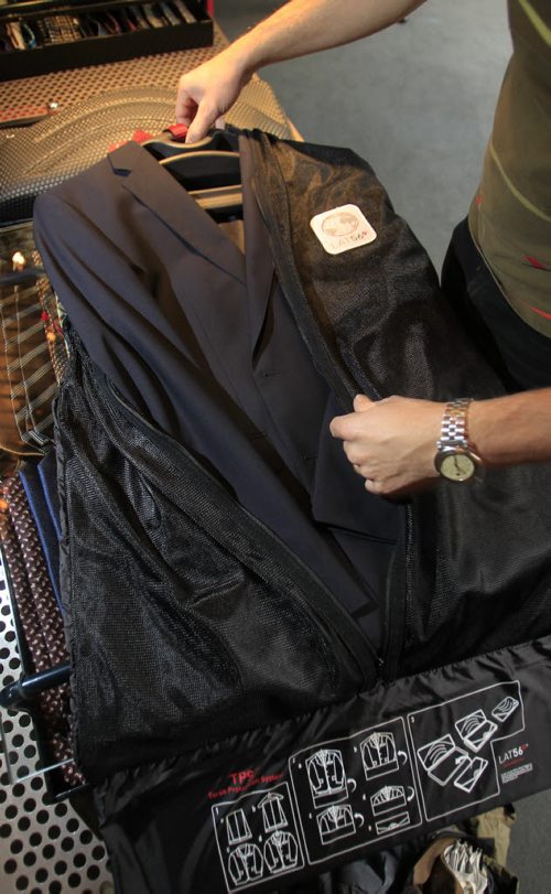 Fashion. Threads. At  Hanford Drewitt, Jon Thiessen of UN Luggage, demonstrates how to travel light. He is using the Lat56 suit-carrier to pack a Boss Travel suit that costs $1,450.00 .  Wayne Glowacki / Winnipeg Free Press Oct. 22 2013