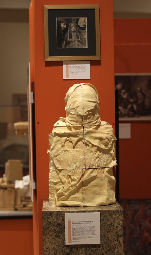 Computer-generated sculpture of a wrapped mumm, "Annie". Cast polyurethane.  This is the first life-sized, computer-gernerated image of an Egyptian mummy produced.  It is the result of a 2009 collaboration between the Akhmin Mummy Studies Consortium and the Bioanthropology and Digital Analysis Laboratory at the U of M, Winnipeg, Canada.  The mummy is that of a young, post-adolescent female who died around 220 BC and was buried at Akhmim. Manitoba Museum opens new exhibit  - Wrapped The Mummy of Pesed in Alloway Hall,  a temporary exhibit  about the mummification process, ancient Egyptian society or about hieroglyphs.  Oct 22, 2013 Ruth Bonneville Winnipeg Free Press