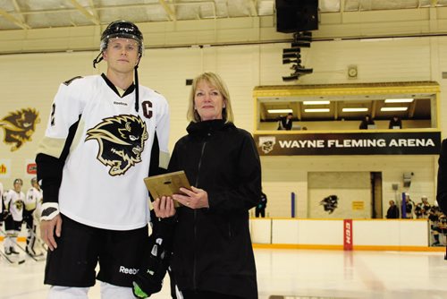 Canstar Community News University of Manitoba Bisons men's hockey captain Dane Crowley receives the first ever Wayne Fleming Legacy Scholarship before Friday night's game against the University of Alberta Golden Bears. Also prior to the game, the arena within the Max Bell Centre on campus was renamed as the Wayne Fleming Arena. (JORDAN THOMPSON)