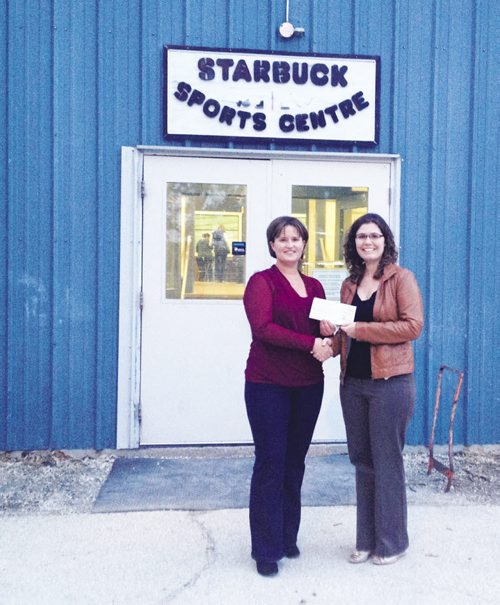 Canstar Community News Oct. 15, 2013 - Farm Credit Corporation representative Angela Duval (left) presents a $500 donation through the FCC's Community Investment Initiative to Nicky Louttit, vice=president of the Starbuck Recreation Committee. (SUBMITTED PHOTO/CANSTAR COMMUNITY NEWS)