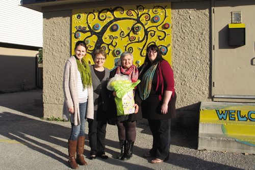 Canstar Community News Oct. 16, 2013 - (Left to right) Elwick Village and Resource Centre co-director Chelsea Hewitt, Burrows MLA Melanie Wight, artist Ursula Neufeld and Elwick Village co-director Kirstie Lindsay in front of Elwick Village's new mosaic. (JARED STORY, CANSTAR COMMUNITY NEWS, THE TIMES)