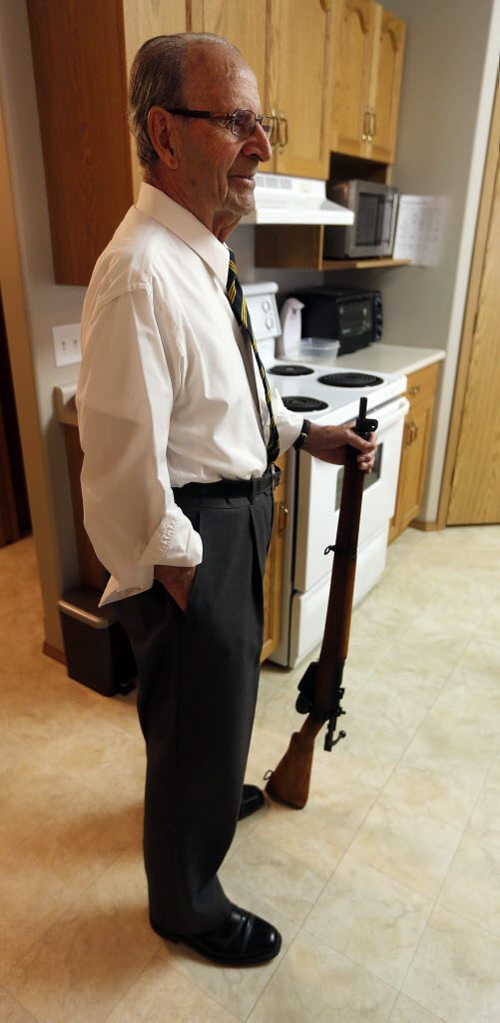 In his kitchen holding a WW2 vintage Lee-Enfield  .303 bolt action magazine fed rifle British like the kind  he used in the army - Harvey Friesen joined the PPCLI at age 16 in 1943 and was  kept in the  service in  Canada until he was 18  but the war had ended preventing him from going over seasto fight. .He lives in Winkler and helped create a WW1 WW2 Cenotaph in the Town of Winkler  - Remembrance Day Feature Äì Mennonite soldiers  who joined the army during WW2 were shunned by their  community upon their return  after WW2  , some  formed their own church Altona United Church  started in 1953  -Randy Turner story  KEN GIGLIOTTI / Oct. 23 2013 / WINNIPEG FREE PRESS