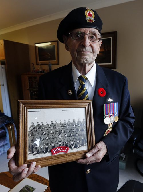 Friesen  with  his 1943 unit photo , in legion  blazer and WW2 medals - Harvey Friesen joined the PPCLI at age 16 in 1943 and was  kept in the  service in  Canada until he was 18  but the war had ended preventing him from going over seas to fight. .He lives in Winkler and helped create a WW1 WW2 Cenotaph in the Town of Winkler  - Remembrance Day Feature Äì Mennonite soldiers  who joined the army during WW2 were shunned by their  community upon their return  after WW2 some formed their own church Altona United Church  started in 1953  -Randy Turner story  KEN GIGLIOTTI / Oct. 23 2013 / WINNIPEG FREE PRESS