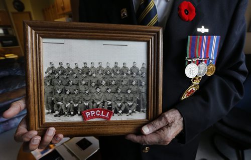 Harvet Friesen  with  poppy , WW2 medals  and his 1943 PPCLI unit photo- Harvey Friesen joined the PPCLI at age 16 in 1943 and was  kept in the  service in  Canada until he was 18  but the war had ended preventing him from going over seas to fight. .He lives in Winkler and helped create a WW1 WW2 Cenotaph in the Town of Winkler  - Remembrance Day Feature Äì Mennonite soldiers  who joined the army during WW2 were shunned by their  community upon their return  after WW2 some  they formed their own church Altona United Church  started in 1953  -Randy Turner story  KEN GIGLIOTTI / Oct. 23 2013 / WINNIPEG FREE PRESS