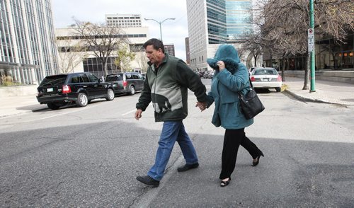 Glen Abraham and wife Debbie MacPhaill- Abraham leave the Lawcourts building where they were testifying during the Brian Sinclair Inquiry. They are the couple who first noticed and told security about a man they didn't think was breathing in the waiting room. 131024 - October 24, 2013 MIKE DEAL / WINNIPEG FREE PRESS