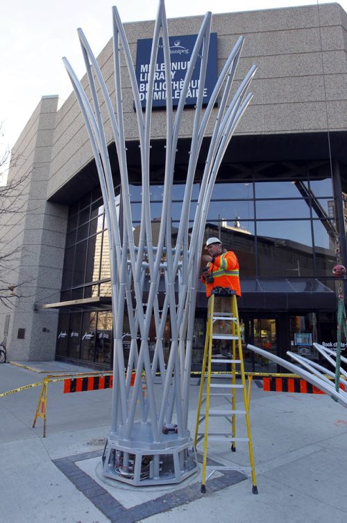 A Funnelator is part of Implement Phase I of the streetscape program on Donald Street from Portage to Graham. The prototypical development of the funnelator was being installed by service tech paul Howard. Its 30 ft tall. Led multicoloured art installation. Made in Texas. BORIS MINKEVICH / WINNIPEG FREE PRESS  October 25, 2013
