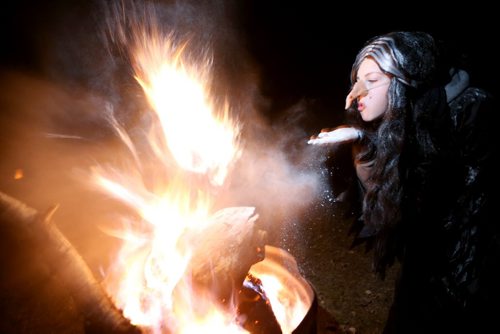 Kayla Zielke, in the role of the Witch Hazel blowing some magic into the fire at the Halloween at the Hill at the Birds Hill Park Ranch, Saturday, October 26, 2013. (TREVOR HAGAN/WINNIPEG FREE PRESS)
