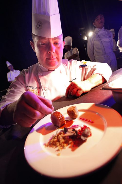 October 25, 2013 - 131025  -    Timothy Palmer of The Velvet Glove puts the finishing touches to an appetizer dish at Gold Medal Plates at the Convention Centre Friday, October 25, 2013. Gold Medal Plates is an annual competition that celebrates Canadas culinary stars while raising funds for the Canadian Olympic Foundation. Eight of Winnipegs best chefs -- Timothy Palmer (The Velvet Glove), Eric Lee (Pizzeria Gusto), Kelly Cattani  (Elements the Restaurant, by Diversity), Tristan Foucault (Peasant Cookery), Terry Gereta (Mise, Haute Prairie Cuisine), Simon Resch (Terrace in the Park), Michael Schafer (Sydneys at the Forks) and Jason Sopel (Chaise Restaurant & Lounge)-- will be competing John Woods / Winnipeg Free Press