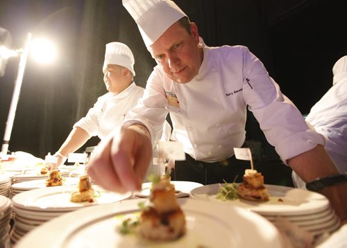 October 25, 2013 - 131025  -    Terry Gereta of Mise, Haute Prairie Cuisine puts the finishing touches to an appetizer dish at Gold Medal Plates at the Convention Centre Friday, October 25, 2013. Gold Medal Plates is an annual competition that celebrates Canadas culinary stars while raising funds for the Canadian Olympic Foundation. Eight of Winnipegs best chefs -- Timothy Palmer (The Velvet Glove), Eric Lee (Pizzeria Gusto), Kelly Cattani (Elements the Restaurant, by Diversity), Tristan Foucault (Peasant Cookery), Terry Gereta (Mise, Haute Prairie Cuisine), Simon Resch (Terrace in the Park), Michael Schafer (Sydneys at the Forks) and Jason Sopel (Chaise Restaurant & Lounge)-- will be competing John Woods / Winnipeg Free Press