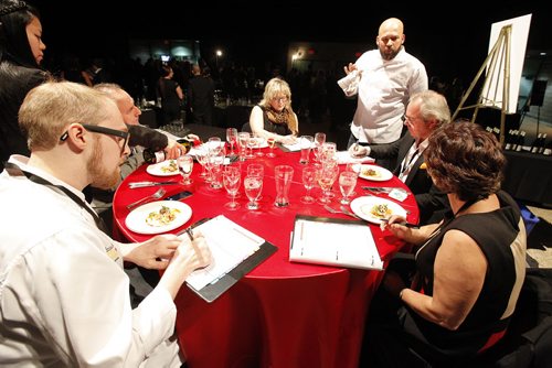 October 25, 2013 - 131025  -    Judges speak to Eric Lee, an entrant, after he entered his appetizer during the Gold Medal Plates competition at the Convention Centre Friday, October 25, 2013. Gold Medal Plates is an annual competition that celebrates Canadas culinary stars while raising funds for the Canadian Olympic Foundation. Eight of Winnipegs best chefs -- Timothy Palmer (The Velvet Glove), Eric Lee (Pizzeria Gusto), Kelly Cattani  (Elements the Restaurant, by Diversity), Tristan Foucault (Peasant Cookery), Terry Gereta (Mise, Haute Prairie Cuisine), Simon Resch (Terrace in the Park), Michael Schafer (Sydneys at the Forks) and Jason Sopel (Chaise Restaurant & Lounge)-- will be competing John Woods / Winnipeg Free Press