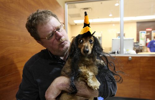 Doug Speirs and his daughter Kayleigh dress their dogs Bogey also known as Mr. X (white dog) and Zoe (weiner dog) in various halloween costumes for dogs while at PetSmart.   See Doug's column for further info. Ruth Bonneville / Winnipeg Free Press