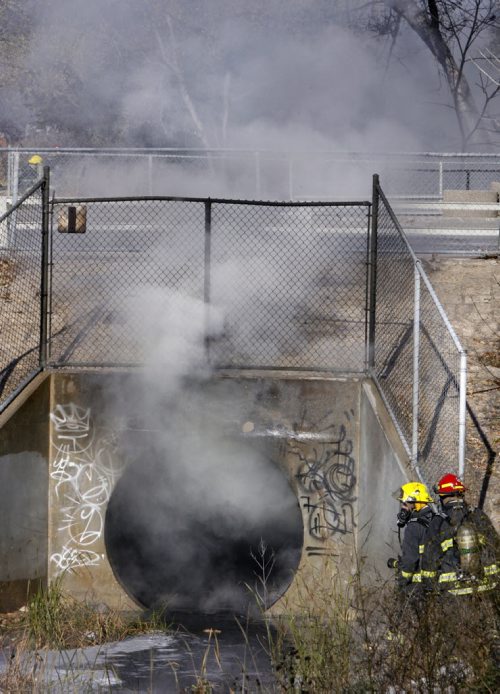 Winnipeg Fire Fighters extinguished a fire Tuesday afternoon in a culvert  for the Truro Creek that flows under Portage Ave. near Albany st. The fire sent up  thick smoke that closed traffic on Portage Ave. east and west bound lanes.   Wayne Glowacki / Winnipeg Free Press Oct. 29 2013