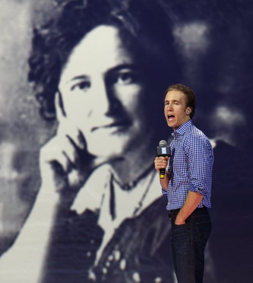Craig Kielberg  on stage with Nellie McClung photo in background  from slide presentation- - - WE Day Manitoba , movement of young people for global  social change starts Wednesday at the MTS Centre will feature speakers and performers Martin Sheen ,Martin Luther King 111  Shawn Desman, the Kenyan Boys Choir  as well as the founders in pic during Tuesday's MTS Centre sound check and rehearsal Craig ( wearing shirt ) and Marc ( suit jacket)  Kielburger  KEN GIGLIOTTI / Oct. 29 2013 / WINNIPEG FREE PRESS