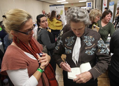 Temple Grandin gives Marjorie Birch a autograph on her book during break at autism conference  at University of Manitoba- Temple is autistic and world renowned animal science expert and autism expert who transformed ways livestock are handled in North America and what people know about autism.-See Carol Sanders story- Oct 29, 2013   (JOE BRYKSA / WINNIPEG FREE PRESS)