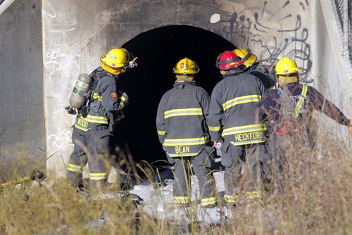 Fire broke out in a culvert that goes under Portage Ave. near Albany. BORIS MINKEVICH / WINNIPEG FREE PRESS  October 29, 2013