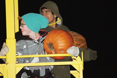 Canstar Community News The Jubilee Mennonite Church hosted a pumpkin fling event for Grade 6-12 students Friday evening that saw kids hoisted high up into the air with the help of two cranes, where they were challenged to send their pumpkins plummeting into a barrel filled with water down below. (JORDAN THOMPSON)