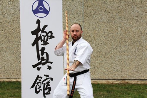 Canstar Community News Sean Devlin with the Kyokushin banner. (JORDAN THOMPSON)
