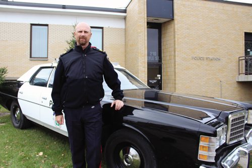 Canstar Community News Sgt. Kelly Dennison out front of the Lyle Street police station Wednesday afternoon where a police cruiser used in 1978 was driven down from the Winnipeg Police Museum and showcased on the front lawn. (JORDAN THOMPSON)