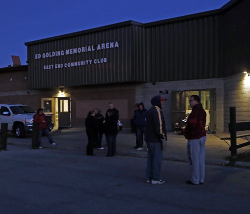 arena and Community club volunterrs gather outside arean before dawn - Transcona's Ed Golding Memorial Arena , East End Community Club is closed after an overnight incident where a car car traveling through a lane way crashed through double steel doors damaging the area ice plant causing the evacuation of the arena a near by homes Äì a funeral is scheduled for later today no word on if the area will reopen at this time , WPG Fire Hazmat  will take reading  at 7:30 am , it is believed police were chasing the car that ran into the building   KEN GIGLIOTTI / Oct. 30 2013 / WINNIPEG FREE PRESS