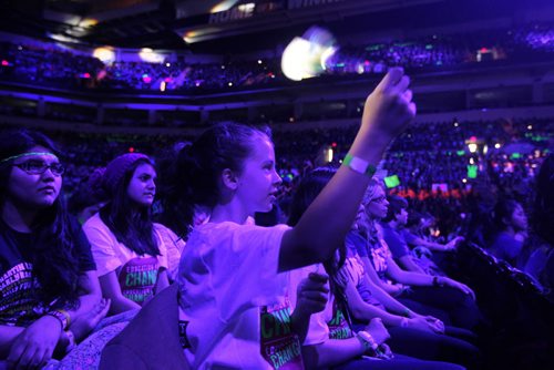 Kara Hatcher of St. George School twirls a glow lights while celebrating  the events on stage at the  3rd annual We Day events at MTS Centre Wednesday. October 30,  2013 Ruth Bonneville / Winnipeg Free Press