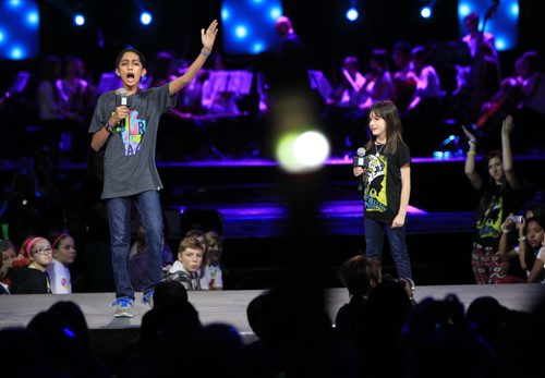 Youth speakers Hannah Alper (right) and Vishal Vijay give their motivational messages to the crowd at the the WE DAY event in the MTS Centre Wednesday.  Wayne Glowacki / Winnipeg Free Press Oct. 30 2013