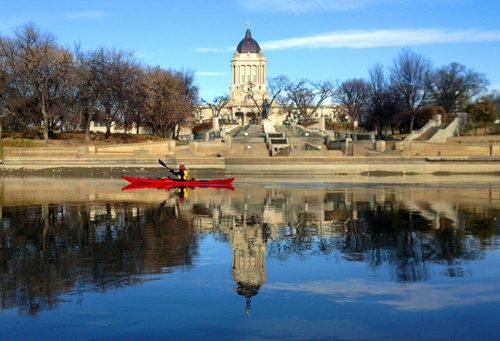 Kayaker Cheryl Jerome paddles past the Legislature on the Assiniboine River. Cold temperatures didn't stop her and her kayak partner to get their last paddle of the year in. BORIS MINKEVICH / WINNIPEG FREE PRESS. Oct. 30, 2013