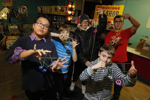 Newbridge Toy Store has started a yo yo night every Wednesday. Kids, teens and any adults interested in learning yo yo tricks are welcome to come down to the store and give 'er a try.  Jean Relleve, Quinn Mudry, Amanda Hebert, Geoffry Wolk, Leon Spivak (front) pose for a group photo. BORIS MINKEVICH / WINNIPEG FREE PRESS  October 30, 2013