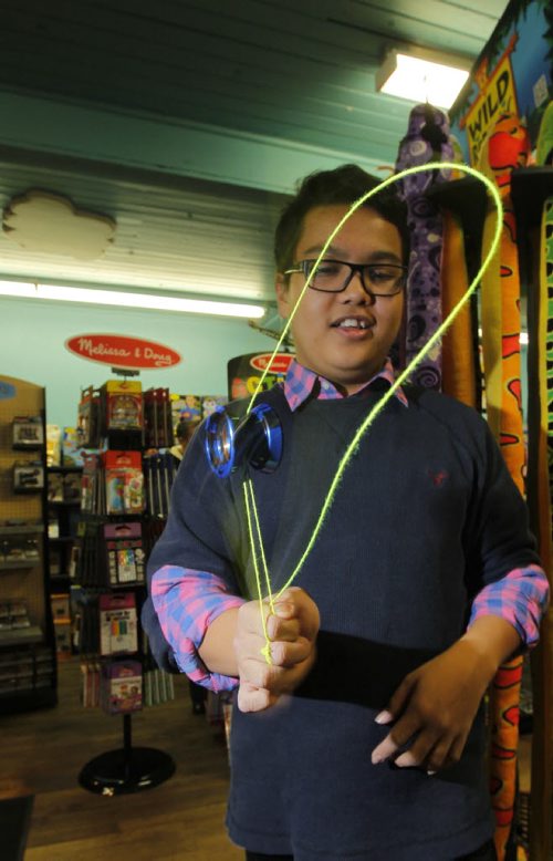 Newbridge Toy Store has started a yo yo night every Wednesday. Kids, teens and any adults interested in learning yo yo tricks are welcome to come down to the store and give 'er a try. In photo Jean Relleve does some tricks. BORIS MINKEVICH / WINNIPEG FREE PRESS  October 30, 2013