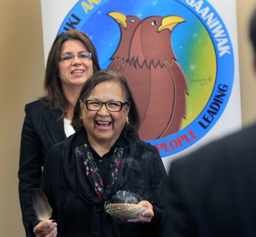 At the official launch of the Aboriginal Relations Division in the Administration Building at City Hall Thursday morning, Elder Margaret Lavallee performs a smudge ceremony by Rhonda Forgues the Manager of the Aboriginal Relations Division.  Aldo Santin story  Wayne Glowacki / Winnipeg Free Press Oct. 31 2013