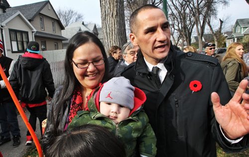 Maria Starr with her 3 month old son Leighton and Kevin Chief minister responsible for the City of Winnipeg as they talk about living in the North End. The provence has proposed changes to liquor legislation that would give police the ability to shut down party houses.  131031 October 31, 2013 Mike Deal / Winnipeg Free Press