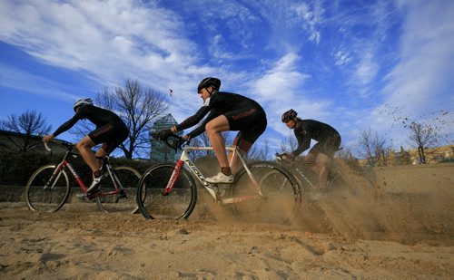 Cyclocross racers John Paul Peters (left), Daniel Enns and Chris Huebner race through a sand spot at The Forks.The 2013 Manitoba Cyclocross Championships at The Forks on Sunday. Cyclocross includes riding on grass, dirt, sand and running over obstacles carrying the bike. 131023 - Wednesday, October 23, 2013 - (Melissa Tait / Winnipeg Free Press)