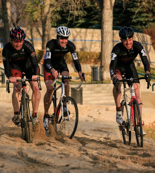Cyclocross racers Chris Huebner (left), John Paul Peters and Daniel Enns race through a sand spot at The Forks. The 2013 Manitoba Cyclocross Championships at The Forks on Sunday. Cyclocross includes riding on grass, dirt, sand and running over obstacles carrying the bike. 131023 - Wednesday, October 23, 2013 - (Melissa Tait / Winnipeg Free Press)