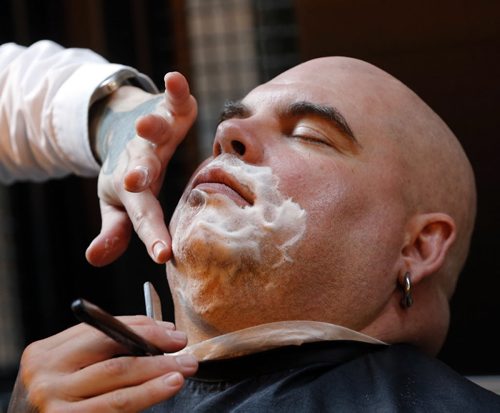 Stdup Movember - in pic Big Daddy Tazz  took part in the Movemeber Kick Off with a straight razor shave  to begin the competition  along with ( not in photo) Former Blue Bomber Linebacker  James ÄúWild Äú West  is in town as a member of the 1988 Grey Cup winning Bombers being honoured at Saturdays' game ,he is taking part in the  Movemeber moustache  shave kick off at Red River College Downtown Campus , we was shaved along with Big Daddy Taz and other Wpg celebrates Äì the  moustache growing contests  supports Prostate and men's cancers  as well a mental health initiatives .It raised  close to $1million  last year  - Taz shaved by DRu Barrow  Nov. 1 2013 / KEN GIGLIOTTI / WINNIPEG FREE PRESS
