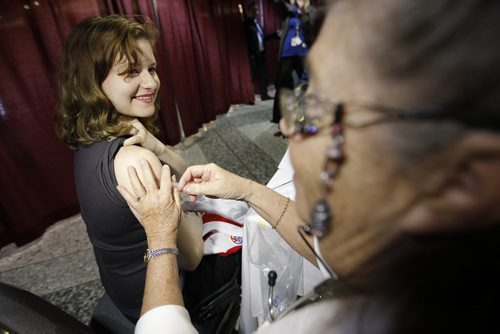November 1, 2013 - 131101  -  A public health nurse gives Tabitha McLelland a flu vaccination at the WRHA flu clinic at Comic Con at the Convention Centre Friday, November 1, 2013. John Woods / Winnipeg Free Press