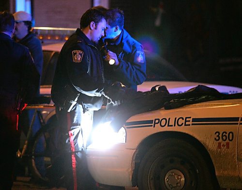 BORIS MINKEVICH / WINNIPEG FREE PRESS  070530 Crime scene on Selkirk Ave. near Andrews. Police hold the scene. A jacket was being inspected at the scene.