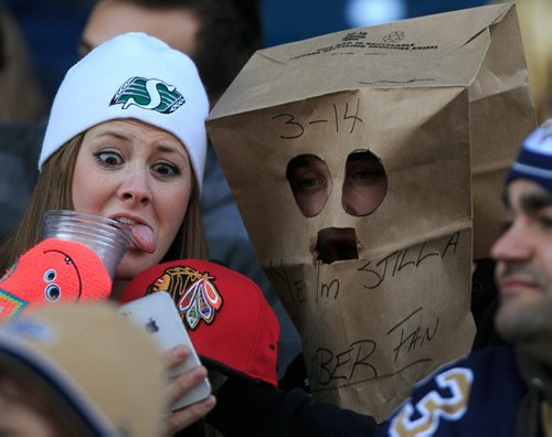 Fans take a photo of their outfits (and a Blackhawks cap) at another Winnipeg Blue Bombers loss at Investors Group Field on Saturday. The Bombers loss the final game of the season against the Hamilton Tiger Cats. 131023 - Wednesday, October 23, 2013 - (Melissa Tait / Winnipeg Free Press)