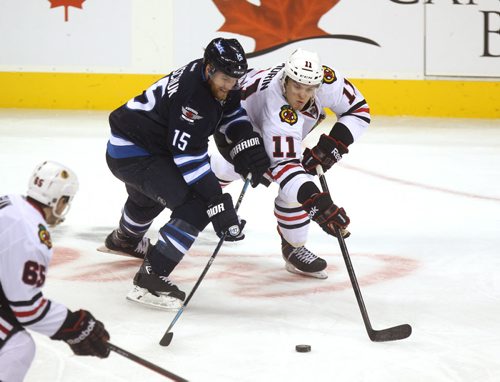 Winnipeg Jets #15  Halischuk  tries to get the puck from Blackhawk #11Jeremy Morin during the 3rd period of play Saturday afternoon at MTS Centre. Winnipeg Jets vs Chicago Blackhawks at MTS Centre Saturday. November 02,,  2013 Ruth Bonneville / Winnipeg Free Press