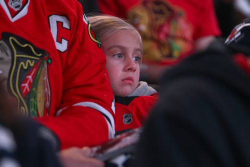 Young five year old Chicago Blackhawks fan Madison Enns cozy's up to her dad while watching them play against The Winnipeg Jets  Saturday afternoon at MTS Centre. November 02,,  2013 Ruth Bonneville / Winnipeg Free Press