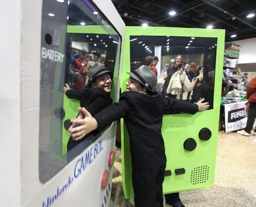 Ten year old Ethan Lalonde gives twoNintendo GameBoy costume wearers a hug as they make their way around the Comic Con event  at the Convention Centre Saturday.  November 02,,  2013 Ruth Bonneville / Winnipeg Free Press