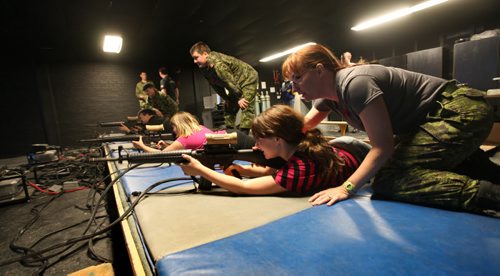 Megan Sawka (front) learns how to shoot with a air gun with the help of Captain Riguidel at Minto Armoury Saturday during their open house.  See Alex Paul story.  November 02,,  2013 Ruth Bonneville / Winnipeg Free Press