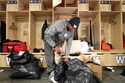 Winnipeg Blue Bomber Wallace Miles packs belongings into plastic bags as he cleans out his locker at the end of the season Sunday morning at Investors Group Field.  131103 November 3, 2013 Mike Deal / Winnipeg Free Press