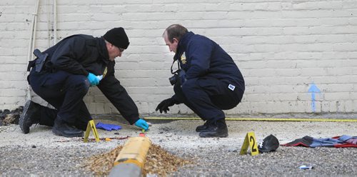 Winnipeg Police Forensic Identification officers by evidence markers alongside the Royal Albert Arms Hotel in a vacant lot between the Albert and the St. Charles Hotel Tuesday morning. web story.  Wayne Glowacki / Winnipeg Free Press Nov. 5. 2013