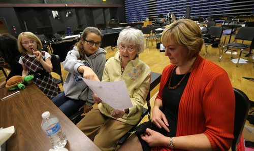 Kay Tworek (middle) and her daughter, Glenlawn Collegiate community liaison worker Margaret Lapenskie, look at part of the script with cast members Carina McLennan (second left) and Anni Irving (left) during rehearsal on Mon., Nov. 4, 2013, for the Glenlawn Collegiate Remembrance Day production of ÄòPig DogÄô, which is based on the Second World War experiences of the 86-year-old Tworek whose Polish family harboured Royal Canadian Air Force pilot Jack Duggan. Photo by Jason Halstead/Winnipeg Free Press