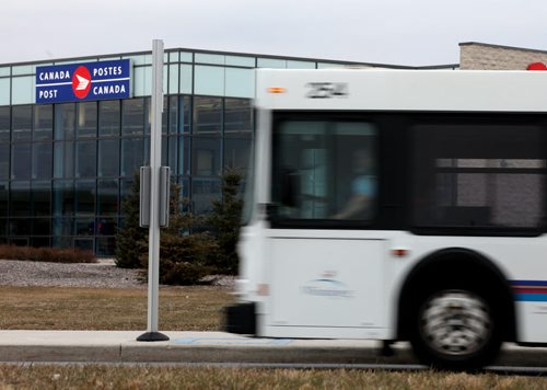 A city transit bus pulls up in front of Canada Posts new Airport Facility. See Bart Kives' tale. November 4, 2013 - (Phil Hossack / Winnipeg Free Press)