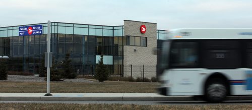 A city transit bus pulls up in front of Canada Posts new Airport Facility. See Bart Kives' tale. November 4, 2013 - (Phil Hossack / Winnipeg Free Press)